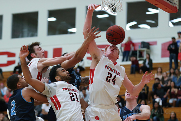 Cal State East Bay Pioneers center Kyle Frakes (35), guard Paramvir Singh (21) and forward Patrick Marr (24)